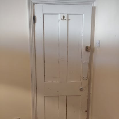 Freshly repainted interior door — satin white finish